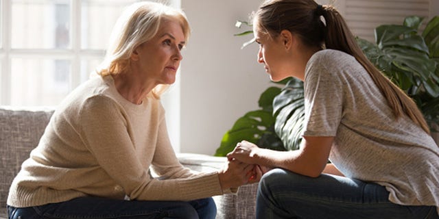 A daughter holds her mom's hands while having a heart-to-heart talk. It’s important for people to get "comfortable having uncomfortable conversations," said Joan Lunden's oldest daughter, Jamie Hess. 