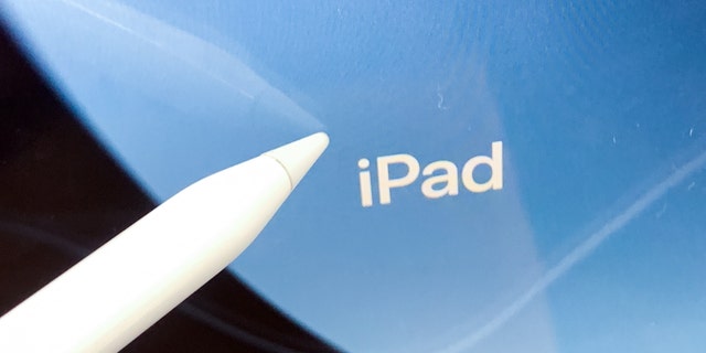 iPad logo displayed on a screen and Apple Pencil are seen in this illustrations photo taken at the store in Krakow, Poland on September 7, 2022. 