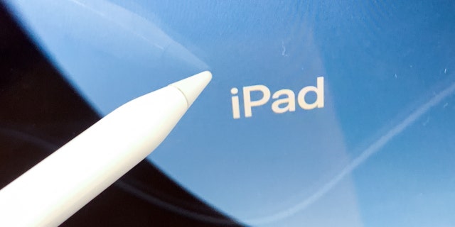 iPad logo displayed on a screen and Apple Pencil are seen in this illustrations photo taken at the store in Krakow, Poland on September 7, 2022. 