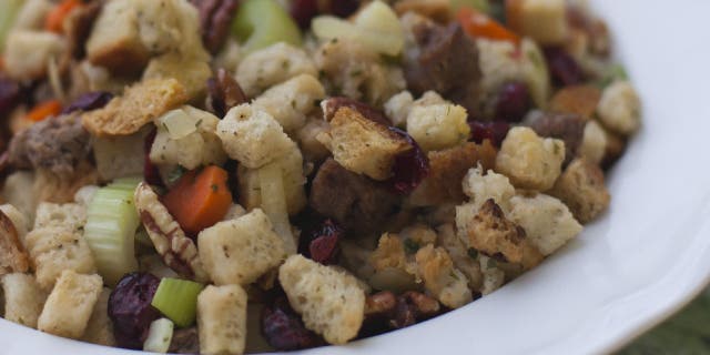 Turkey and sausage are commonly added to Thanksgiving stuffing. Here's a holiday stuffing made with celery, carrots, pecans, cranberries and sausage pieces.