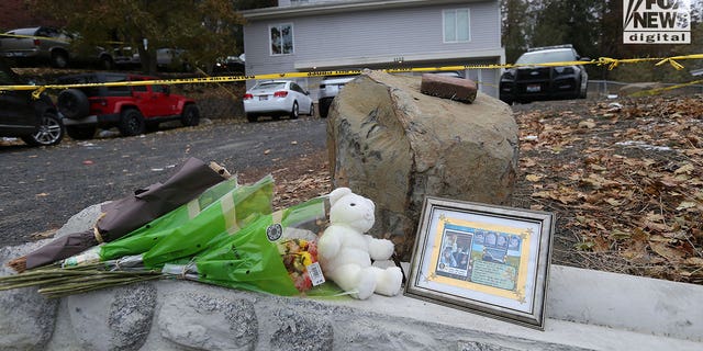 Flowers and a toy bear sit as a memorial at the house where four students were murdered in Moscow, Idaho. 