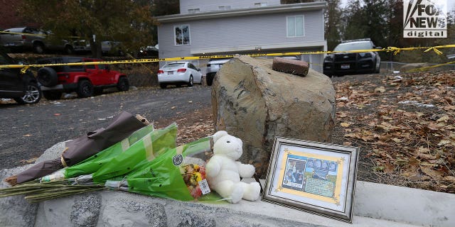 Flowers and a toy bear sit as a memorial at the house where four students were murdered in Moscow, Idaho. 