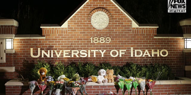 Flowers and stuffed animals are left at the entrance to the University of Idaho on Nov. 14, 2022. Four students were killed over the weekend in an apparent quadruple homicide.