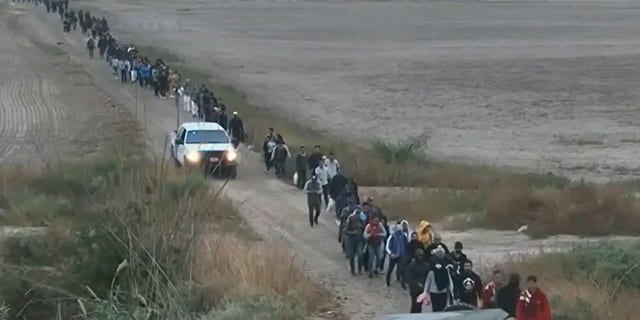Migrants cross into the U.S. in Normandy, Texas, on Nov. 3, 2022.