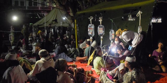 Wounded survivors of an earthquake are being treated in the yard of a hospital in Cianjur on November 21, 2022. (TIMUR MATAHARI/AFP via Getty Images)