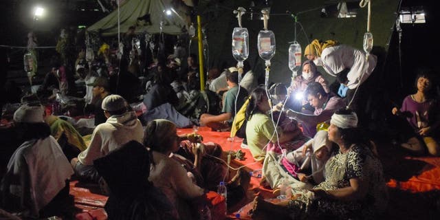 Injured survivors of an earthquake are being treated in the courtyard of a hospital in Cianjur on November 21, 2022. (TIMUR MATAHARI/AFP via Getty Images)