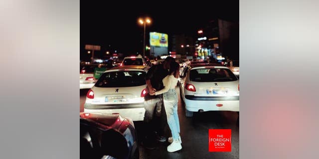 A couple in Iran are openly flouting several government laws, including a requirement for women to wear headscarves and a potential ban on unmarried couples kissing in public, in a unique act of defiance.