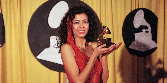 Irene Cara, best known as a singer of movie themes, holds her award for the song "What a Feeling" from the movie Flashdance. She won the award for Best Pop Vocal performance by a Female.