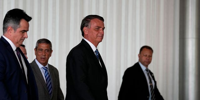 Brazilian President Jair Bolsonaro arrives to speak from his official residence of Alvorada Palace in Brasilia, Brazil, Tuesday, Nov. 1, 2022, the leader's first public comments since losing the Oct. 30 presidential runoff. 