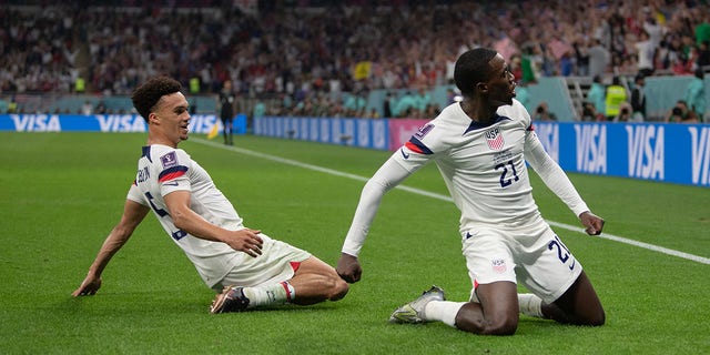 Timothy Weah of USA celebrates scoring with team mate Antonee Robinson during the FIFA World Cup Qatar 2022 Group B match between USA and Wales at Ahmad Bin Ali Stadium on November 21, 2022 in Doha, Qatar.