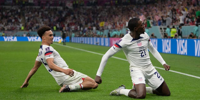 Timothy Weah of USA celebrates scoring with team mate Antonee Robinson during the FIFA World Cup Qatar 2022 Group B match between USA and Wales at Ahmad Bin Ali Stadium on November 21, 2022 in Doha, Qatar.