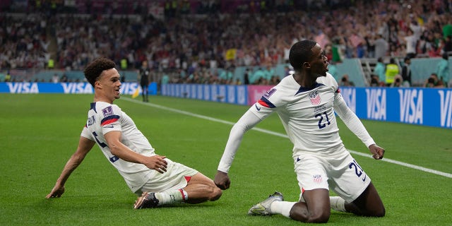 Timothy Weah of USA celebrates scoring with team mate Antonee Robinson during the FIFA World Cup Qatar 2022 Group B match between USA and Wales at Ahmad Bin Ali Stadium on November 21, 2022 in Doha, Qatar.