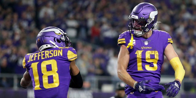 Minnesota Vikings wide receiver Adam Thielen (19) celebrates with teammate Justin Jefferson (18) after catching a 15-yard touchdown pass during the second half against the New England Patriots Thursday, Nov. 24, 2022, in Minneapolis. 