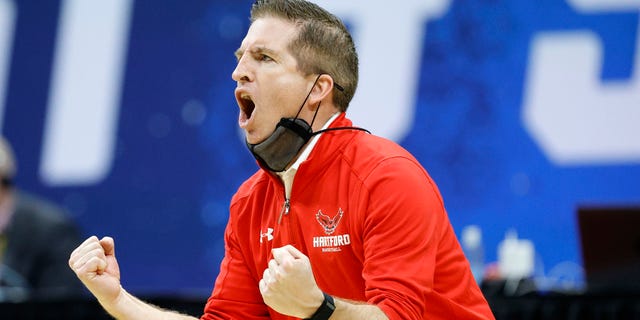 Head coach John Gallagher of the Hartford Hawks reacts during a game against the Baylor Bears in the first round of the 2021 NCAA men's basketball tournament at Lucas Oil Stadium March 19, 2021, in Indianapolis.