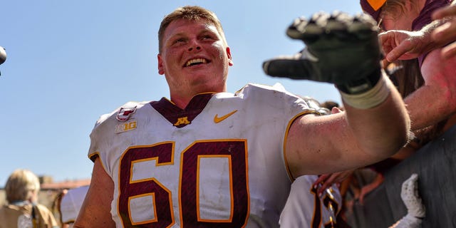 Offensive lineman John Michael Schmitz #60 of the Minnesota Golden Gophers walks off the field after a 30-0 win over the Colorado Buffaloes at Folsom Field on September 18, 2021 in Boulder, Colorado.