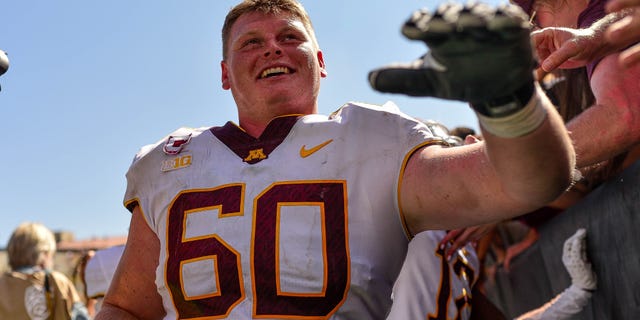 Offensive lineman John Michael Schmitz #60 of the Minnesota Golden Gophers walks off the field after a 30-0 win over the Colorado Buffaloes at Folsom Field on September 18, 2021 in Boulder, Colorado.