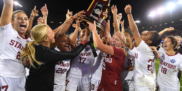 Stanford Cardinal goalie Katie Meyer (19) lifts the trophy after defeating the North Carolina Tar Heels during the Division I women's soccer championship at Avaya Stadium on December 8, 2019 in San Jose, California.
