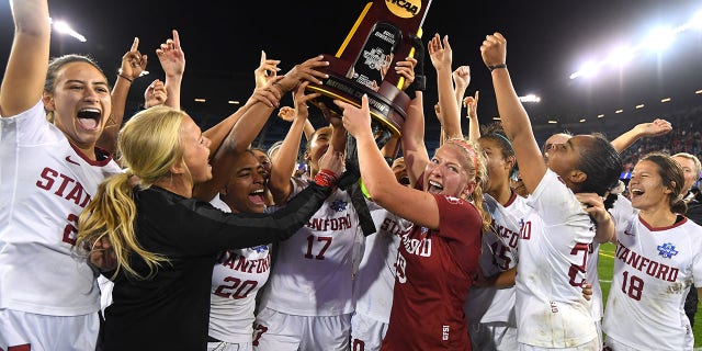 Stanford Cardinal goalie Katie Meyer (19) lifts the trophy after defeating the North Carolina Tar Heels during the Division I women's soccer championship at Avaya Stadium on December 8, 2019 in San Jose, California.