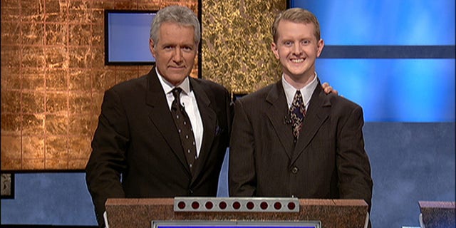 Alex Trebek with Ken Jennings after his earnings from his record-breaking streak on the gameshow surpassed 1 million dollars July 14, 2004, in Culver City, California.