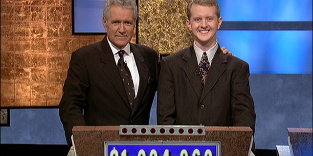 Alex Trebek with Ken Jennings after his earnings from his record-breaking streak on the gameshow surpassed 1 million dollars July 14, 2004, in Culver City, California.