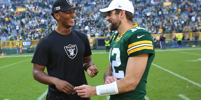 Green Bay Packers quarterback Aaron Rodgers (12) talks with Oakland Raiders quarterback DeShone Kizer after a game at Lambeau Field on October 20, 2019 in Green Bay, Wisconsin. 