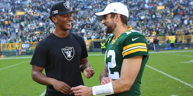 Green Bay Packers quarterback Aaron Rodgers (12) talks with Oakland Raiders quarterback DeShone Kizer after a game at Lambeau Field on October 20, 2019 in Green Bay, Wisconsin.