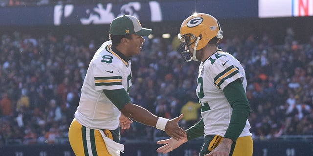 Green Bay Packers quarterbacks DeShone Kizer (9) and Aaron Rodgers (12) shake hands on the field during a game against the Chicago Bears Dec. 16, 2018, at Soldier Field in Chicago. 