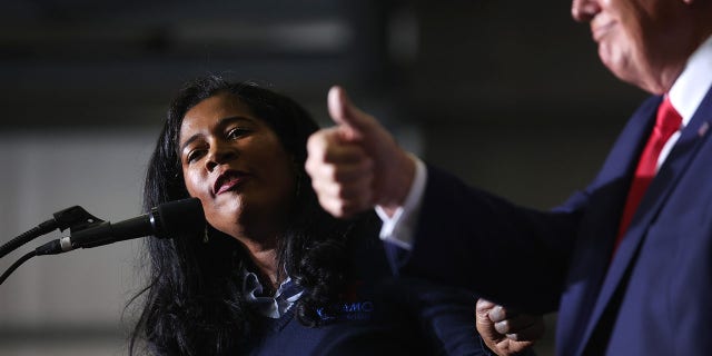 Kristina Karamo, who is running for the Michigan Republican party's nomination for secretary of state, gets an endorsement from former President Donald Trump during a rally on April 2, 2022, near Washington, Michigan. Trump is in Michigan to promote his America First agenda promote several Michigan Republican candidates.