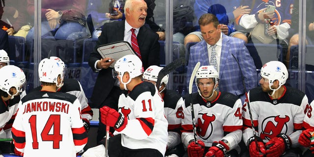 Head coach Lindy Ruff of the New Jersey Devils handles bench duties against the New York Islanders during a preseason game at the Webster Bank Arena at Harbor Yard Oct. 2, 2021, in Bridgeport, Conn.