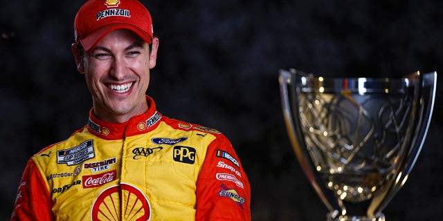 Host Joey Logano laughs