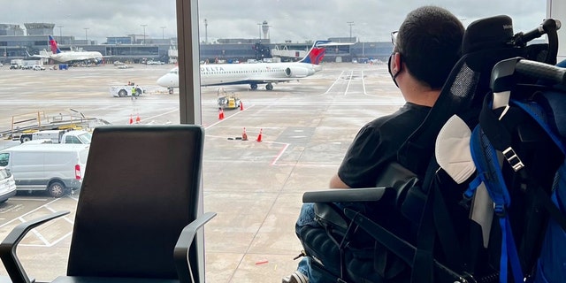 Cory Lee looks out a window at Hartsfield-Jackson Atlanta International Airport in Atlanta.