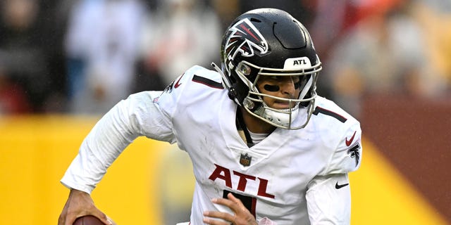 Marcus Mariota #1 of the Atlanta Falcons rolls out of the pocket in the fourth quarter of a game against the Washington Commanders at FedExField on November 27, 2022 in Landover, Maryland.