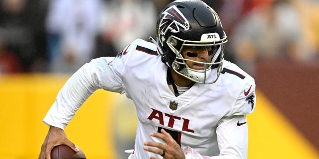 Marcus Mariota #1 of the Atlanta Falcons rolls out of the pocket in the fourth quarter of a game against the Washington Commanders at FedExField on November 27, 2022 in Landover, Maryland.