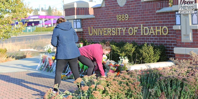 People lay flowers and pay respect at the University of Idaho on Tuesday, November 15, 2022. Four students were murdered in Moscow, Idaho over the weekend.