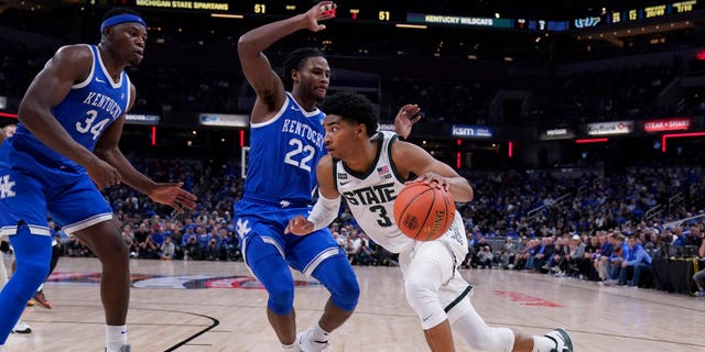 Michigan State guard Jaden Akins (3) drives against Kentucky forward Oscar Tshiebwe (34) and guard Cason Wallace (22) during the second half of an NCAA college basketball game, Tuesday, Nov. 15, 2022, in Indianapolis.