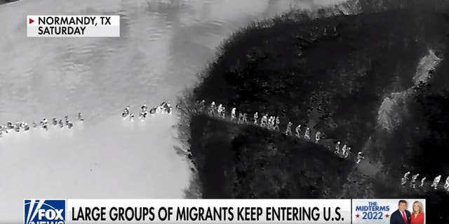 Migrants cross the US-Mexico border.  (FoxNews)