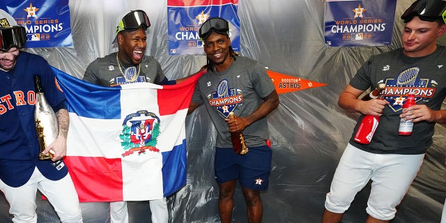 Ryan Pressly, Héctor Neris and Rafael Montero of the Houston Astros celebrate with the World Series trophy in the clubhouse after the Astros defeated the Phillies, 4-1, in Game 6 of the 2022 World Series at Minute Maid rk Nov. 5, 2022, in Houston.