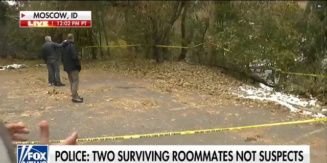 Police blocked off a wide area with police tape behind the home where four college students were murdered eight days ago in Moscow, Idaho. 