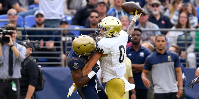 Notre Dame wide receiver Braden Lenzy (0) makes a touchdown catch behind the back of Navy cornerback Mbiti Williams, Jr. (7) during a game Nov. 12, 2022, at M and T Bank Stadium in Baltimore, Md.