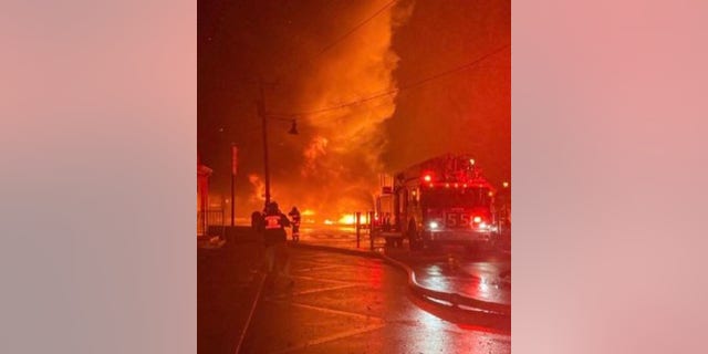 A fire engine is at the scene of a massive Old Mystic seaport blaze.