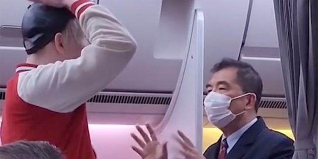 A passenger was caught arguing with and mocking a flight attendant after not receiving water on a plane.