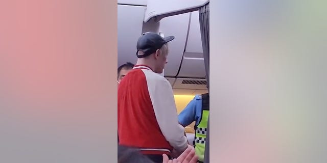 The passenger ultimately was escorted off the plane, water bottle in hand.