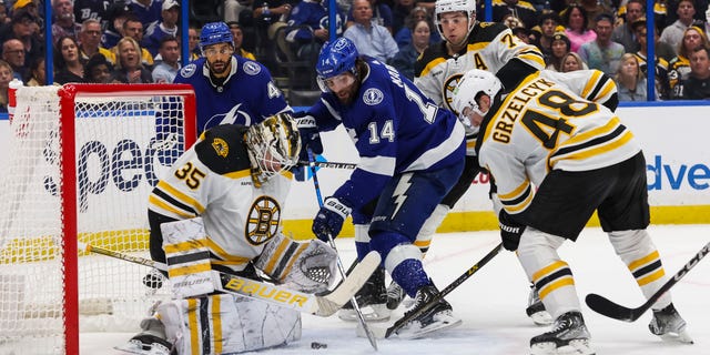 Tampa Bay Lightning's Pat Maroon #14 skates against Boston Bruins goaltender Linus Ullmark #35 and Matt Grzelcyk #48 during the second period at Amalie Arena on November 21, 2022 in Tampa, Florida.