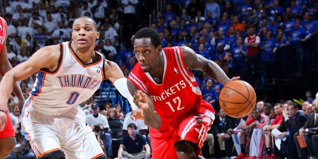 Patrick Beverley of the Rockets drives against Russell Westbrook of the Thunder during the NBA Playoffs on April 24, 2013, at the Chesapeake Energy Arena in Oklahoma City, Oklahoma.