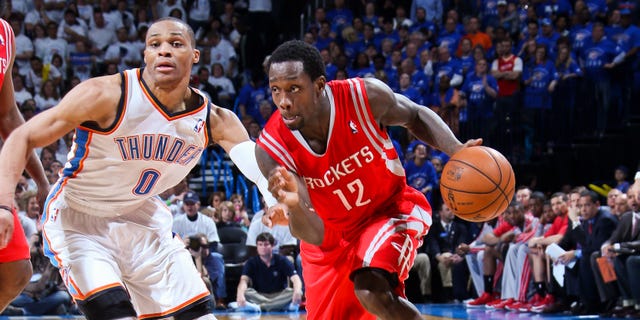 Patrick Beverley of the Rockets drives against Russell Westbrook of the Thunder during the NBA Playoffs on April 24, 2013, at the Chesapeake Energy Arena in Oklahoma City, Oklahoma.