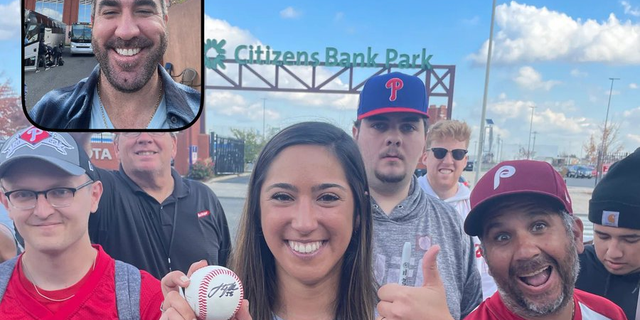 Phillies fan Stephanie Di Ianni poses with a signed Justin Verlander baseball before Game 3 of the World Series in Philadelphia, Pa. 