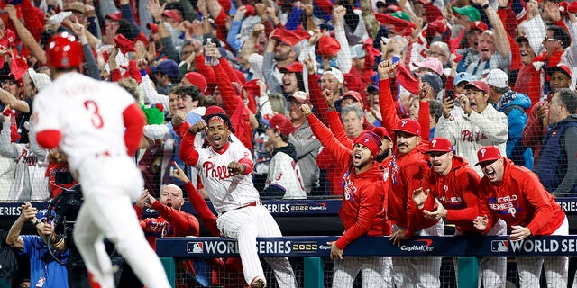 The Philadelphia Phillies dugout reacts after Bryce Harper #3 of the Philadelphia Phillies hits a two-run home run against the Houston Astros during the first inning in Game Three of the 2022 World Series at Citizens Bank Park on November 01, 2022 in Philadelphia, Pennsylvania. 