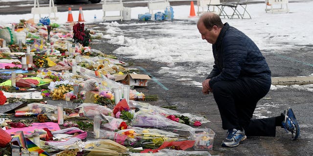 Colorado Gov. Jared Polis visits a memorial set up outside Club Q in Colorado Springs on Nov. 29, 2022.