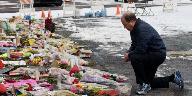 Colorado Gov. Jared Polis visits a memorial set up outside Club Q in Colorado Springs on Nov. 29, 2022.