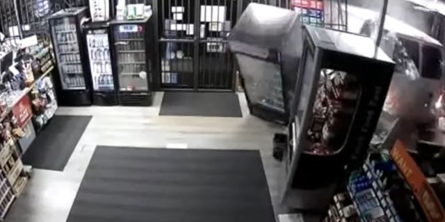 The suspects drove a white van through the front of a Fastrak Food Mart at 4:35 a.m. Tuesday and stole an ATM, police said.